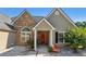 Charming home featuring a stone facade and a welcoming red front door at 1625 Alcovy River Dr, Dacula, GA 30019