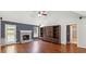 Bright living room with hardwood floors, fireplace, and built-in shelving at 1625 Alcovy River Dr, Dacula, GA 30019