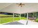 Covered patio with vaulted ceilings, fan, and views of the landscaped backyard at 1625 Alcovy River Dr, Dacula, GA 30019