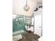 Stunning bathroom featuring an open glass shower and standalone soaking tub illuminated by a modern light fixture at 190 Country Club Dr, Hiram, GA 30141