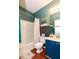 Brightly lit bathroom with blue vanity and a tub/shower combination at 190 Country Club Dr, Hiram, GA 30141