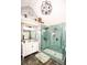 Bright bathroom featuring dual-head glass shower, a white vanity, and stylish light fixtures at 190 Country Club Dr, Hiram, GA 30141