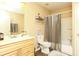 Functional bathroom featuring a vanity with sink, toilet, and a shower-tub combination with curtain at 190 Country Club Dr, Hiram, GA 30141