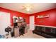 Cozy red bedroom with a futon, desk, and built-in shelves at 190 Country Club Dr, Hiram, GA 30141