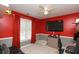 Bright red and gray bedroom with a modern ceiling fan and media center at 190 Country Club Dr, Hiram, GA 30141