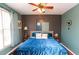 Bedroom with a blue velvet bed, turquoise accents and hardwood floors at 190 Country Club Dr, Hiram, GA 30141
