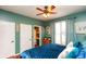 Bedroom with a blue velvet bed, turquoise accents and hardwood floors at 190 Country Club Dr, Hiram, GA 30141