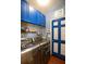 Laundry room with blue cabinets, geometric wallpaper, and a side-by-side washer and dryer at 190 Country Club Dr, Hiram, GA 30141