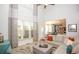 Sunlit living room with high ceilings, large windows, open to the kitchen at 190 Country Club Dr, Hiram, GA 30141