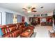 Open living room with large leather sectional, ceiling fan, and a wet bar in the background at 190 Country Club Dr, Hiram, GA 30141