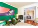 Inviting living room featuring vibrant green walls, comfortable seating, and seamless access to the dining area at 190 Country Club Dr, Hiram, GA 30141