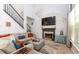Bright and airy living room with a cozy fireplace, vaulted ceilings, and large windows at 190 Country Club Dr, Hiram, GA 30141
