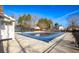 Community pool with a safety cover, surrounded by a fence, lounge area, and mature trees at 190 Country Club Dr, Hiram, GA 30141