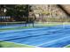 Community tennis court with blue surface and white net, ready for play at 190 Country Club Dr, Hiram, GA 30141