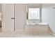Soaking tub in a brightly lit bathroom, perfect for relaxation and unwinding at 3435 Vista Creek Dr, Dacula, GA 30019