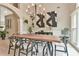 Elegant dining room with a large wooden table, modern chandelier, and neutral decor at 3435 Vista Creek Dr, Dacula, GA 30019