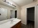 Bathroom featuring a single sink vanity with a large mirror at 1720 New Orleans Way, Mcdonough, GA 30252