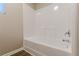 Bathroom featuring a white tub and shower at 1720 New Orleans Way, Mcdonough, GA 30252