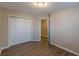 A bedroom with wood-look floors and a closet at 1720 New Orleans Way, Mcdonough, GA 30252