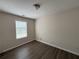 This bedroom features wood-look flooring, a neutral color palette and a window that provides natural light at 1720 New Orleans Way, Mcdonough, GA 30252