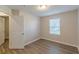 Bedroom with wood-look floors and an open doorway at 1720 New Orleans Way, Mcdonough, GA 30252