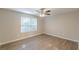 Bright bedroom featuring natural light, a ceiling fan, and beautiful hardwood floors at 1720 New Orleans Way, Mcdonough, GA 30252