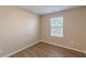 Bright bedroom featuring wood-look flooring and a window at 1720 New Orleans Way, Mcdonough, GA 30252