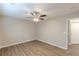 Neutral bedroom featuring natural light, a ceiling fan, and beautiful hardwood floors at 1720 New Orleans Way, Mcdonough, GA 30252