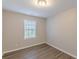 Bedroom with wood-look floors and natural light at 1720 New Orleans Way, Mcdonough, GA 30252