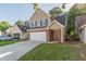 Two-story home featuring a brick-and-vinyl facade with an attached garage and a well-manicured front lawn at 1720 New Orleans Way, Mcdonough, GA 30252