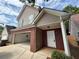 Angle view of the home showing the 2-car garage and front entryway at 1720 New Orleans Way, Mcdonough, GA 30252