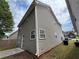 A view of the home's exterior showing the siding, windows, and a well-maintained lawn at 1720 New Orleans Way, Mcdonough, GA 30252
