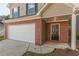 The home has a brick and vinyl facade, an attached garage, and a covered front entrance at 1720 New Orleans Way, Mcdonough, GA 30252