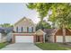 Two-story home featuring a brick-and-vinyl facade with an attached garage and a well-manicured front lawn at 1720 New Orleans Way, Mcdonough, GA 30252
