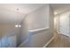 Open and airy hallway with chandelier and hardwood floors adds a touch of sophistication at 1720 New Orleans Way, Mcdonough, GA 30252