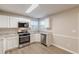 Well-lit kitchen featuring white cabinets, stainless steel appliances, and granite countertops at 1720 New Orleans Way, Mcdonough, GA 30252