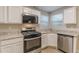 Close-up of the Kitchen showcasing stainless steel appliances and granite countertops at 1720 New Orleans Way, Mcdonough, GA 30252