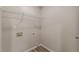 Practical laundry room with sleek wood-look flooring and convenient overhead shelving at 1720 New Orleans Way, Mcdonough, GA 30252
