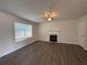 Living room featuring hardwood floors, fireplace, and ample natural light at 1720 New Orleans Way, Mcdonough, GA 30252