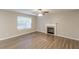Living room featuring a fireplace and large window offering natural light at 1720 New Orleans Way, Mcdonough, GA 30252