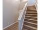 Carpeted staircase with white trim, leading to the upper level, adjacent to the main entrance at 1720 New Orleans Way, Mcdonough, GA 30252