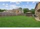 Expansive backyard featuring lush green grass, a charming gazebo, and a well-maintained wooden fence at 2109 Cape Ivey Ct, Dacula, GA 30019