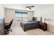 Well-lit bedroom with desk and dark wood furnishings at 2109 Cape Ivey Ct, Dacula, GA 30019