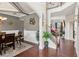 Elegant dining room with wainscoting, stylish chandelier, and a view of the staircase at 2109 Cape Ivey Ct, Dacula, GA 30019