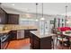 Kitchen showcasing granite counters, stainless steel appliances, hardwood floors, and an island cooktop at 2109 Cape Ivey Ct, Dacula, GA 30019