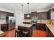 Contemporary kitchen features stainless steel appliances, granite countertops, and dark wood cabinetry at 2109 Cape Ivey Ct, Dacula, GA 30019