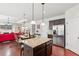 Open concept kitchen with granite counters, stainless steel appliances, and views to the living room at 2109 Cape Ivey Ct, Dacula, GA 30019