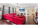 Cozy living room with a fireplace, plush sofa, and a view of the backyard through large windows at 2109 Cape Ivey Ct, Dacula, GA 30019
