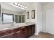 Bathroom features a double sink vanity with granite countertop, framed mirrors, and walk-in glass shower at 2109 Cape Ivey Ct, Dacula, GA 30019