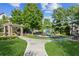 Beautifully landscaped playground with a pergola, benches and lush green grass at 2109 Cape Ivey Ct, Dacula, GA 30019